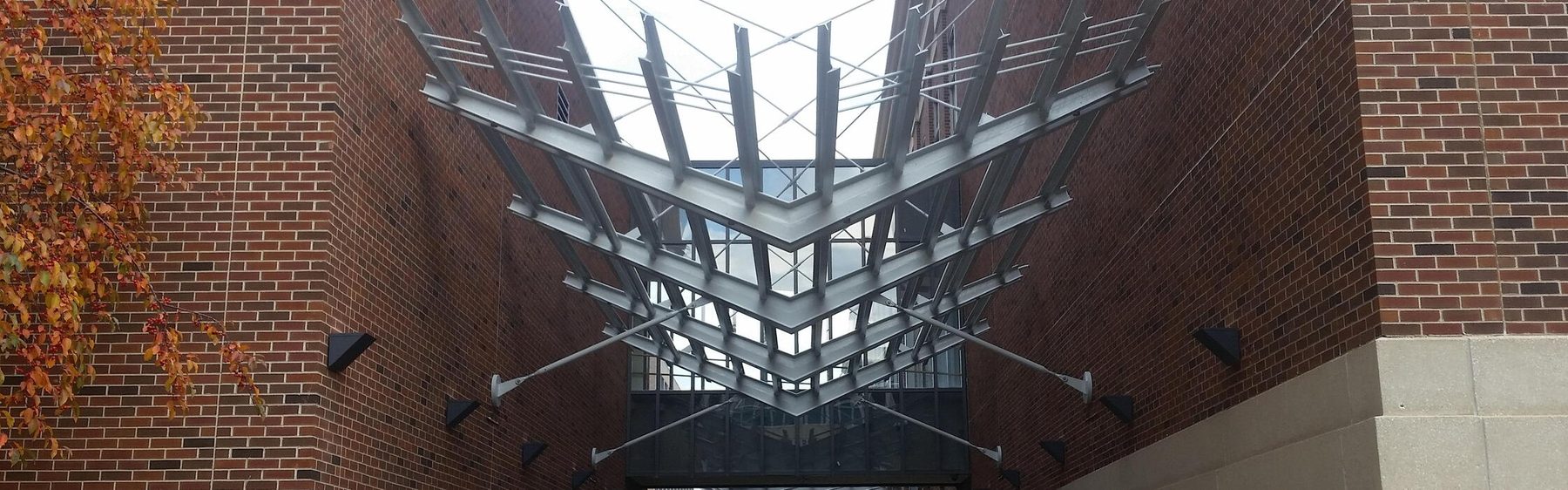Erected exposed architectural steel canopy at the University of Minnesota Scholars Walk, between Keller Hall and the Mechanical Engineering Building